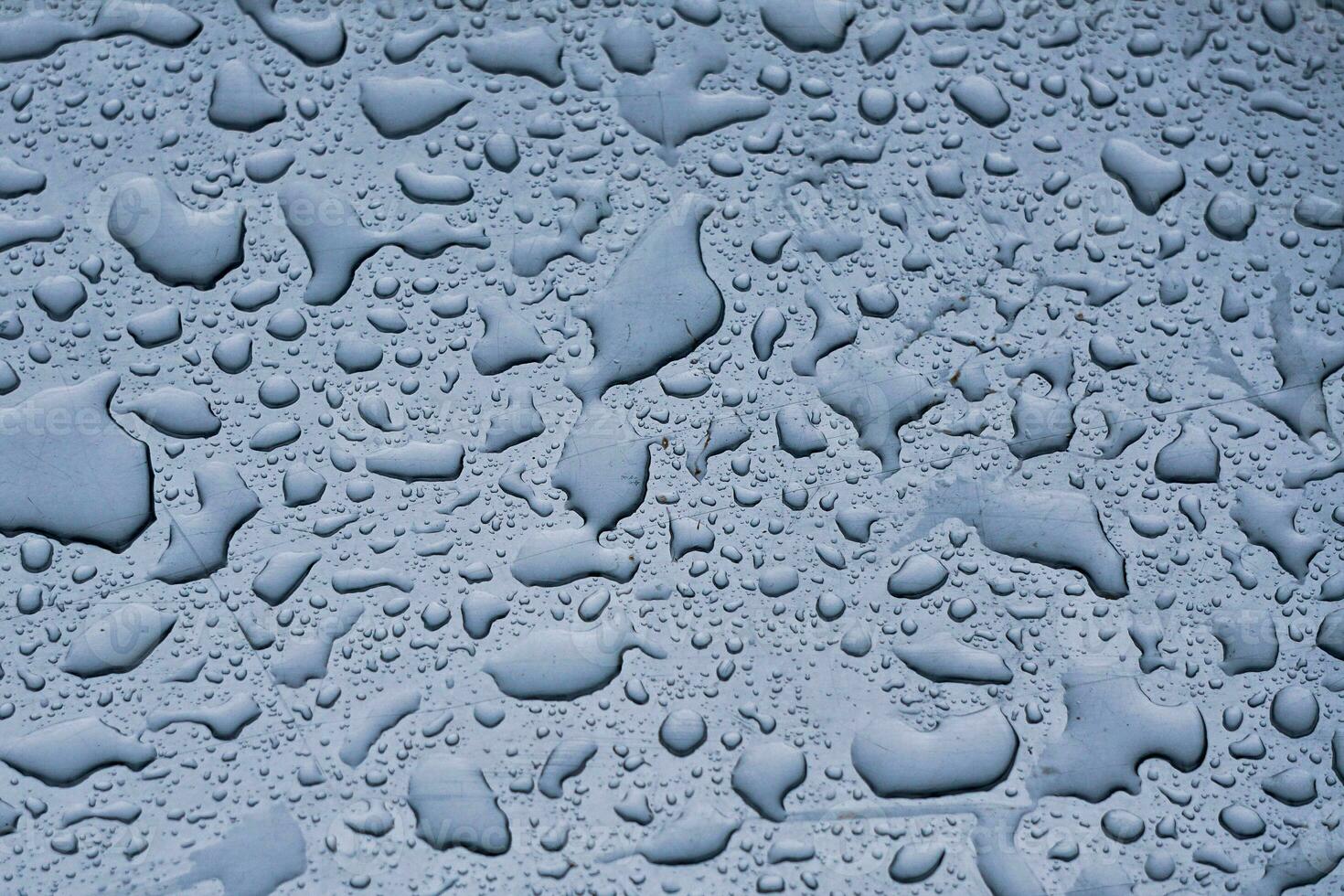 raindrops on the window in rainy days, abstract and blue background photo