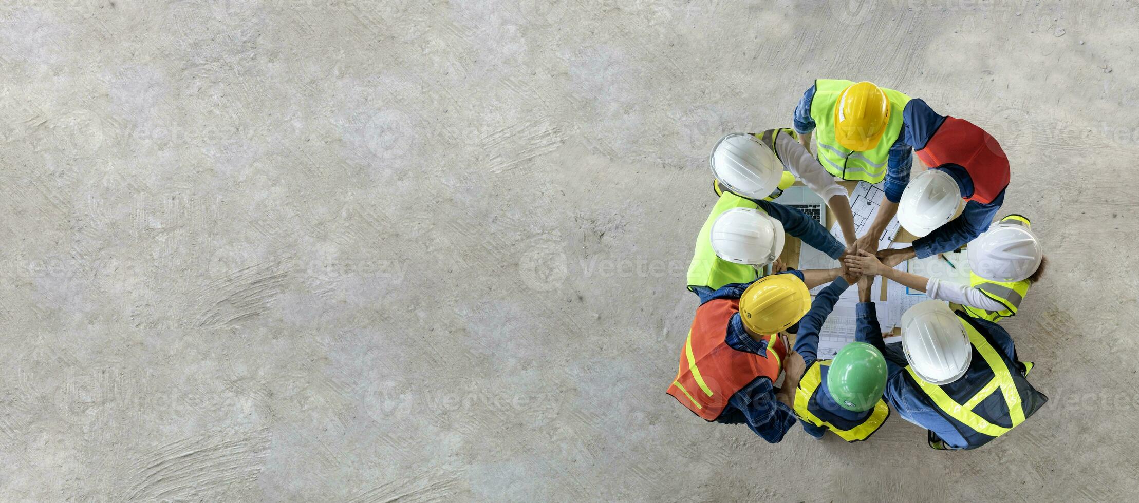 Top view of engineer, architect, contractor and foreman having unity agreement meeting at the construction building site with floor plan for real estate development project industry and housing usage. photo