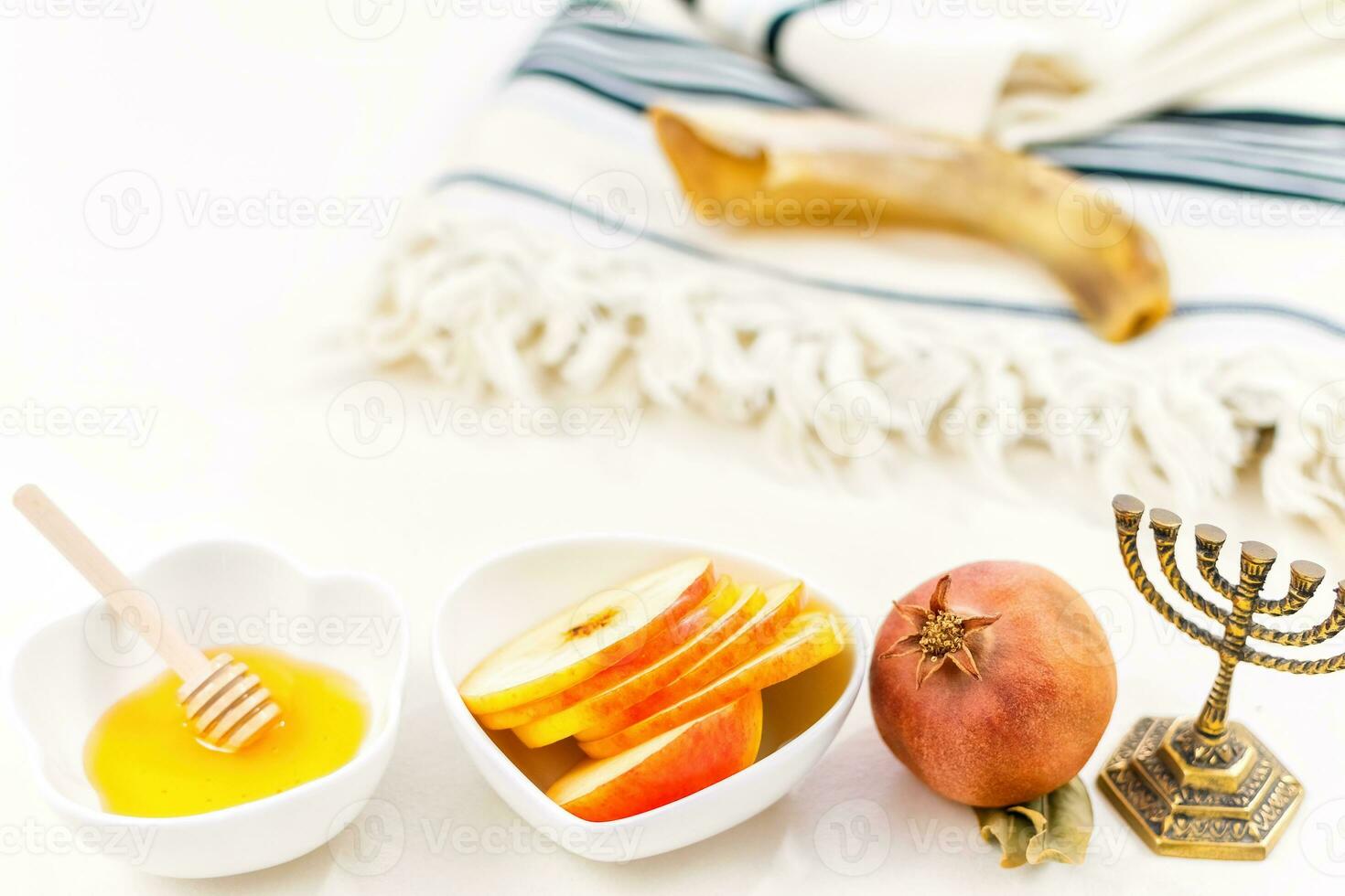 Rosh Hashanah jewish new year holiday celebration concept. Honey and apples over white background. photo