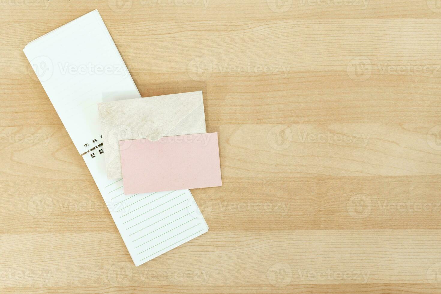 Wedding invitation mockup card with paper and envelope, on wooden desk. photo