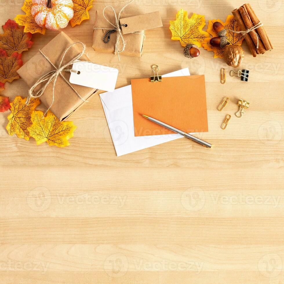 Thanksgiving With Pumpkins, gifts And greeting On Wooden Table. Fall Background. photo