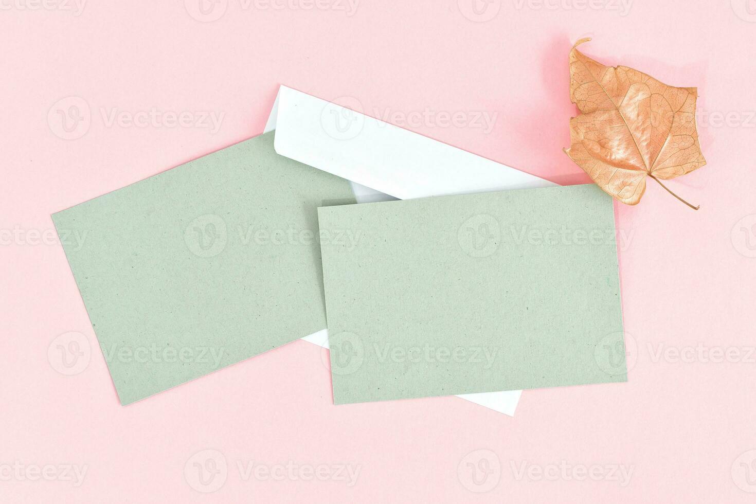 Greeting card mockup with envelope on pink background. Card mockup with copy space. photo