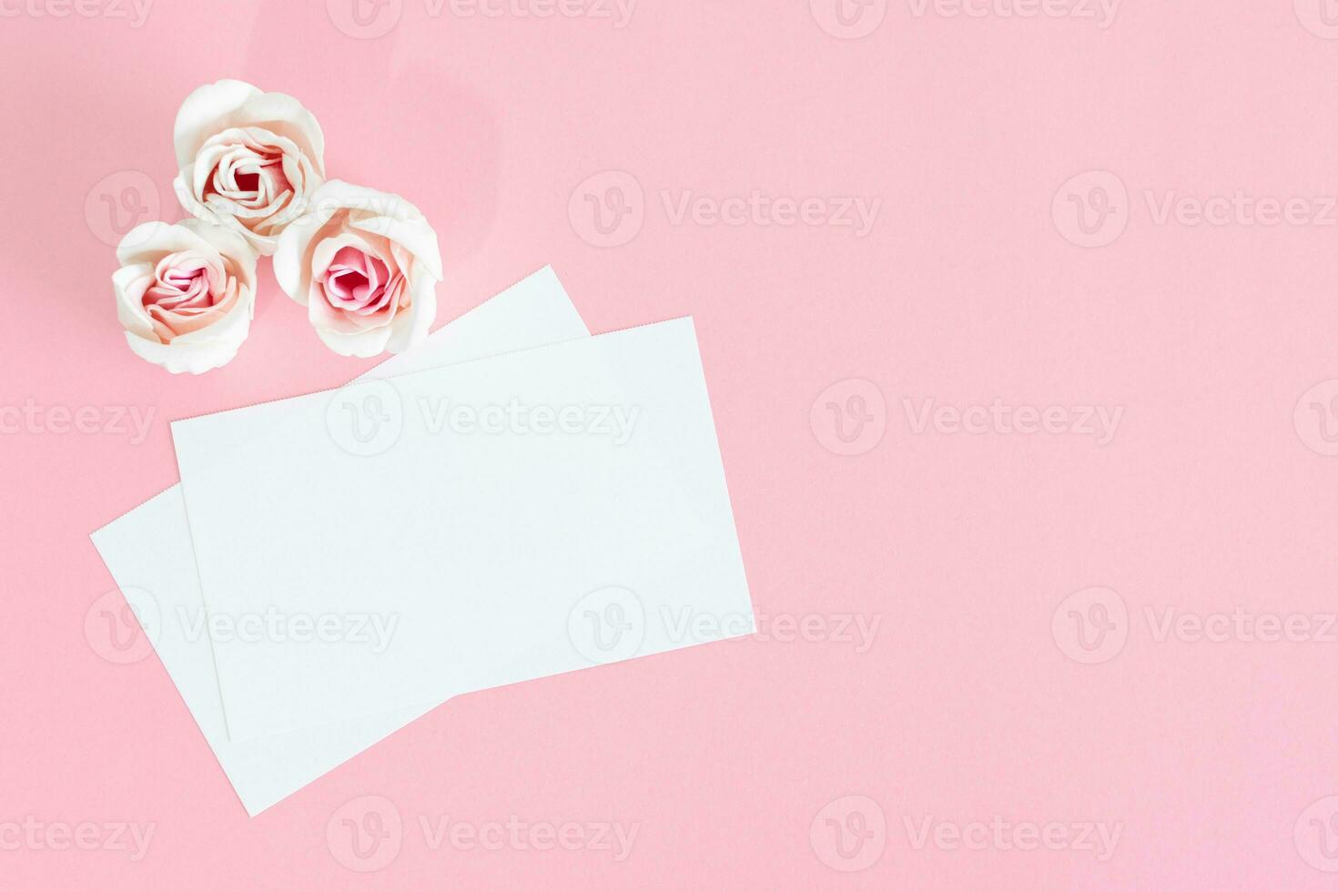 Blank white greeting card with pink rose flowers. Mock up. photo