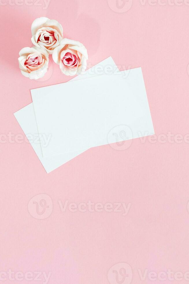 Blank white greeting card with pink rose flowers. Mock up. photo