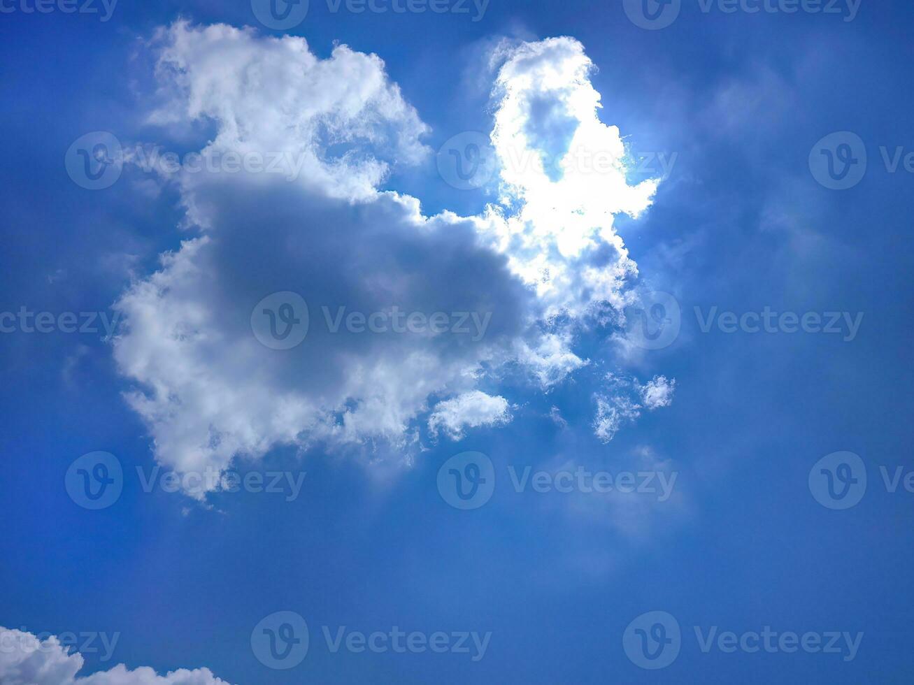 Low angle view of beautiful bright blue sky and white fluffy clouds, cloudscape, natural shape, bright day in summer photo