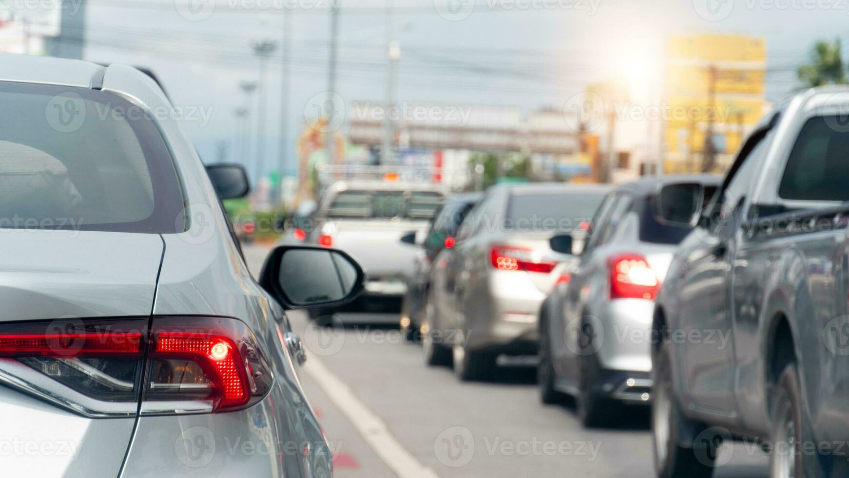 Rear side of car with turn on brake light. Cars on the road heading towards the goal of the trip. Traffic in the city of Thailand. photo