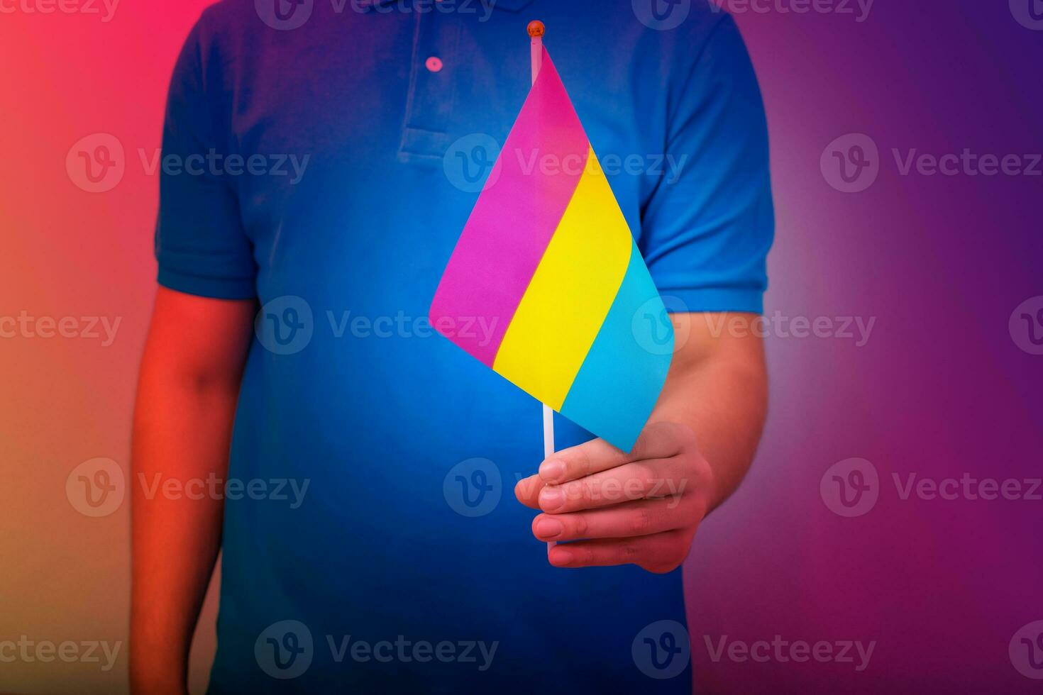 Hand holding flag in pan sexual pride colors. photo