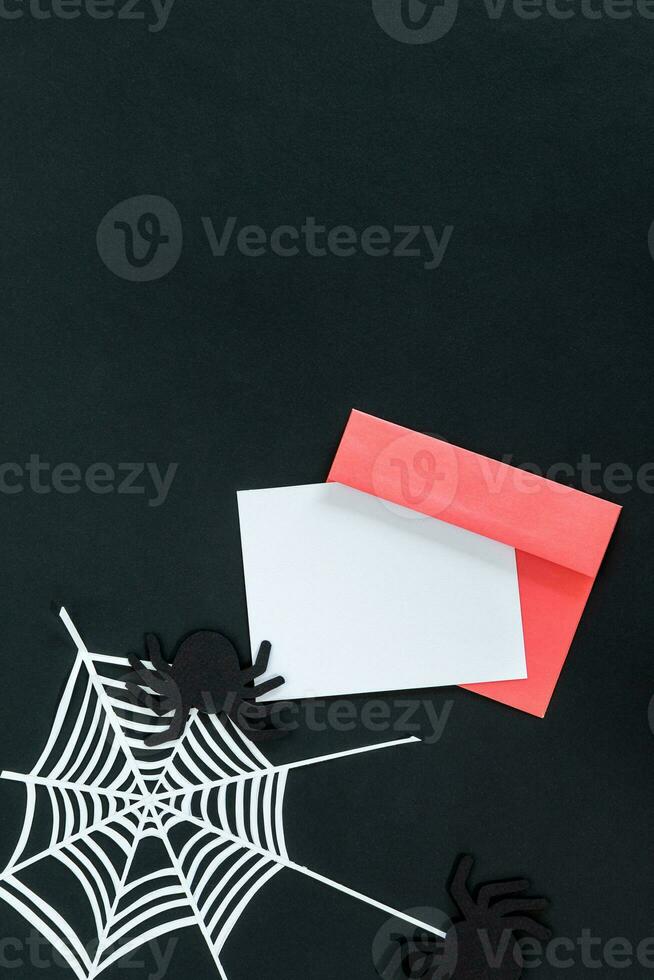 Creative halloween composition card, pink envelope, spider, spider web on black background with place for text, top view. photo