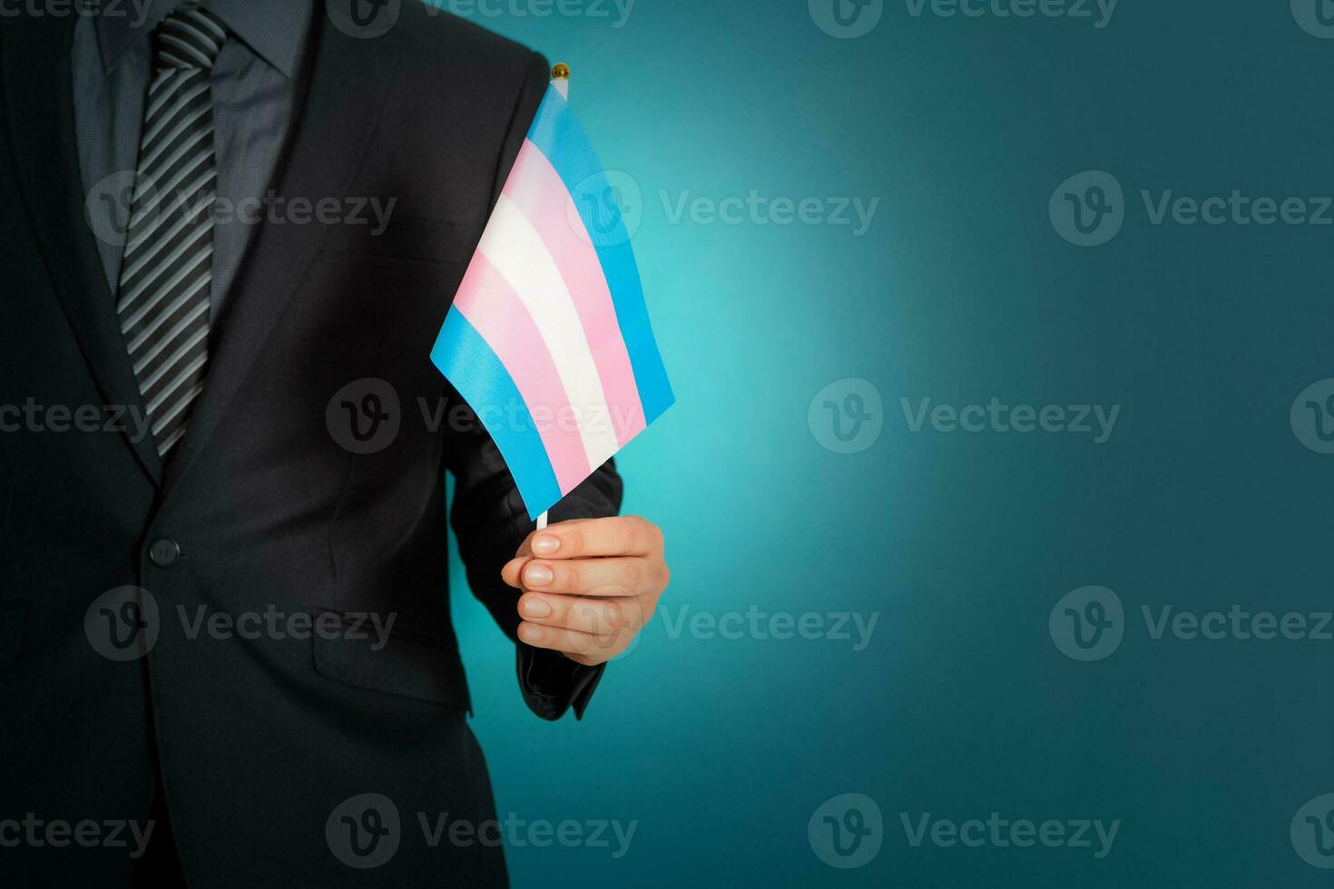 Businessman hand holding flag in transgender pride colors. photo