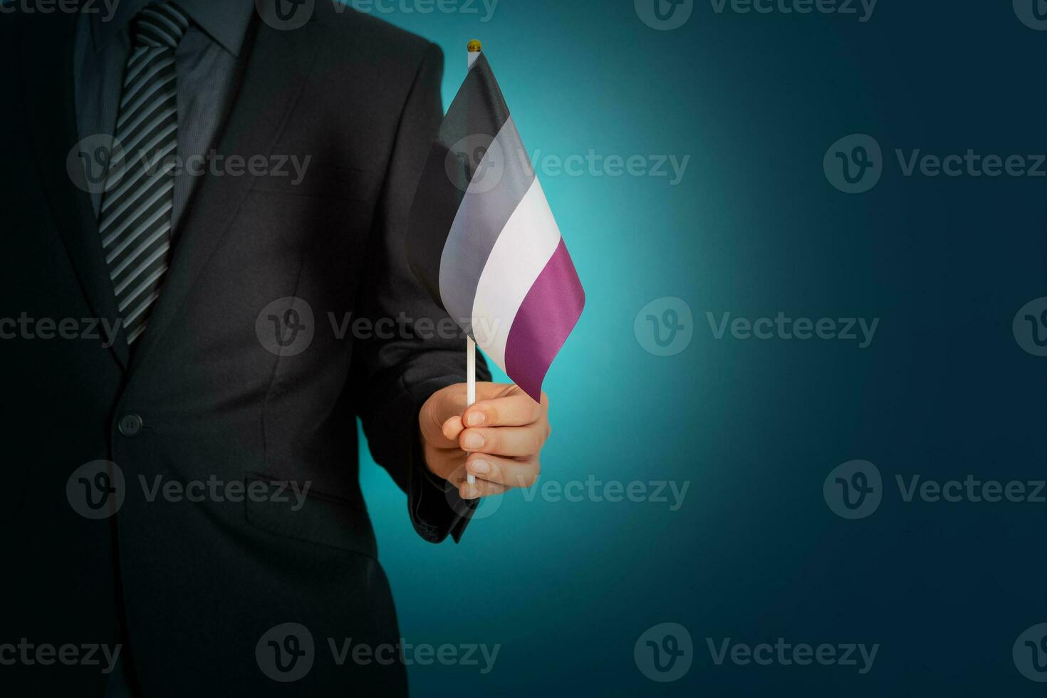 Businessman hand holding flag in asexual pride colors. photo