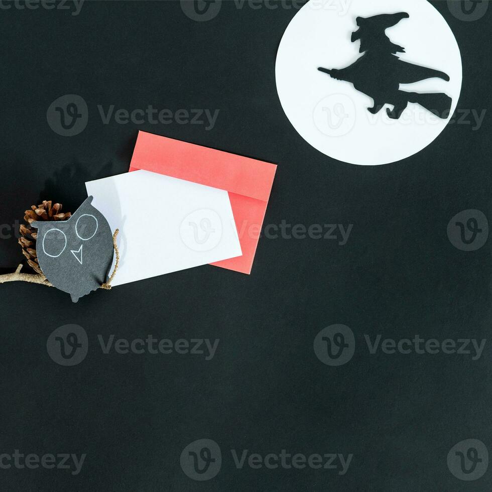 Halloween holiday invitation with witch on black background. photo