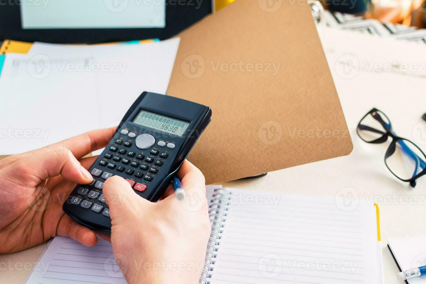businessman working with financial report using calculator. Top view. photo