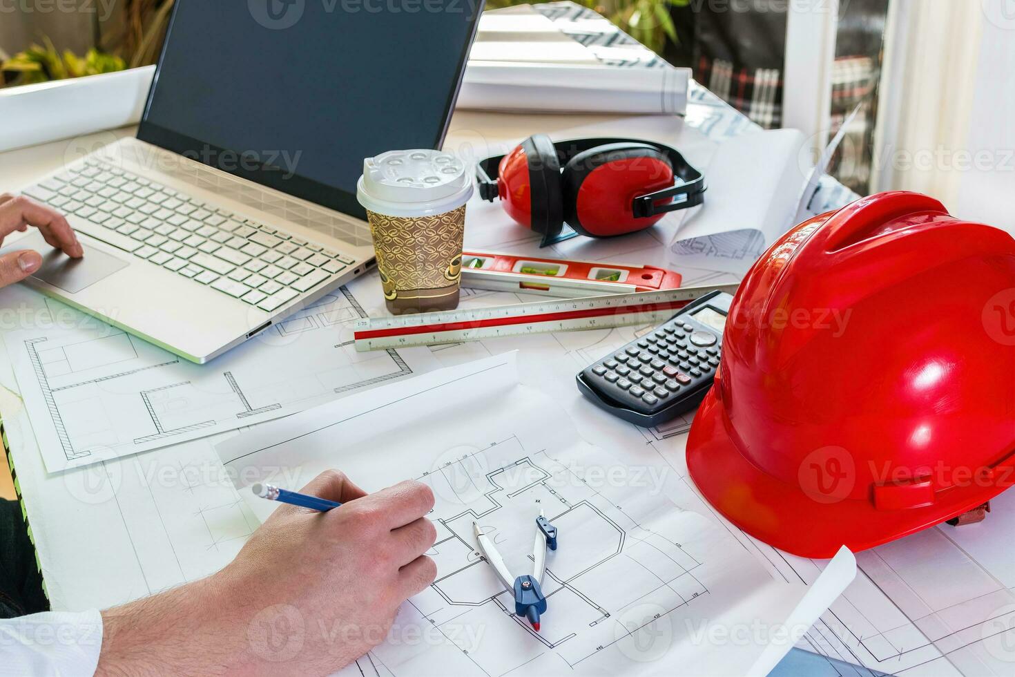 Man hand working of Architect sketching project on blueprint at site construction work. photo