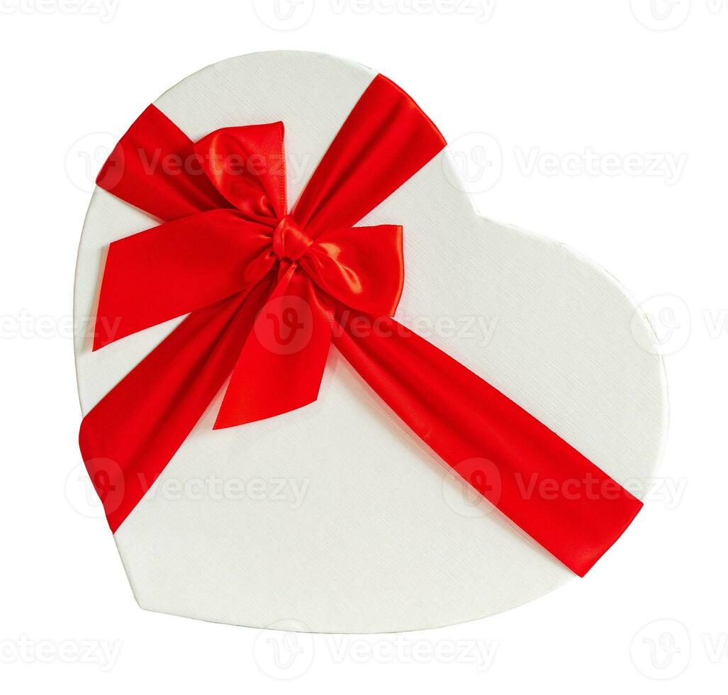 Heart-shaped gift box and a red ribbon on a blank background, Valentine's day concept. photo