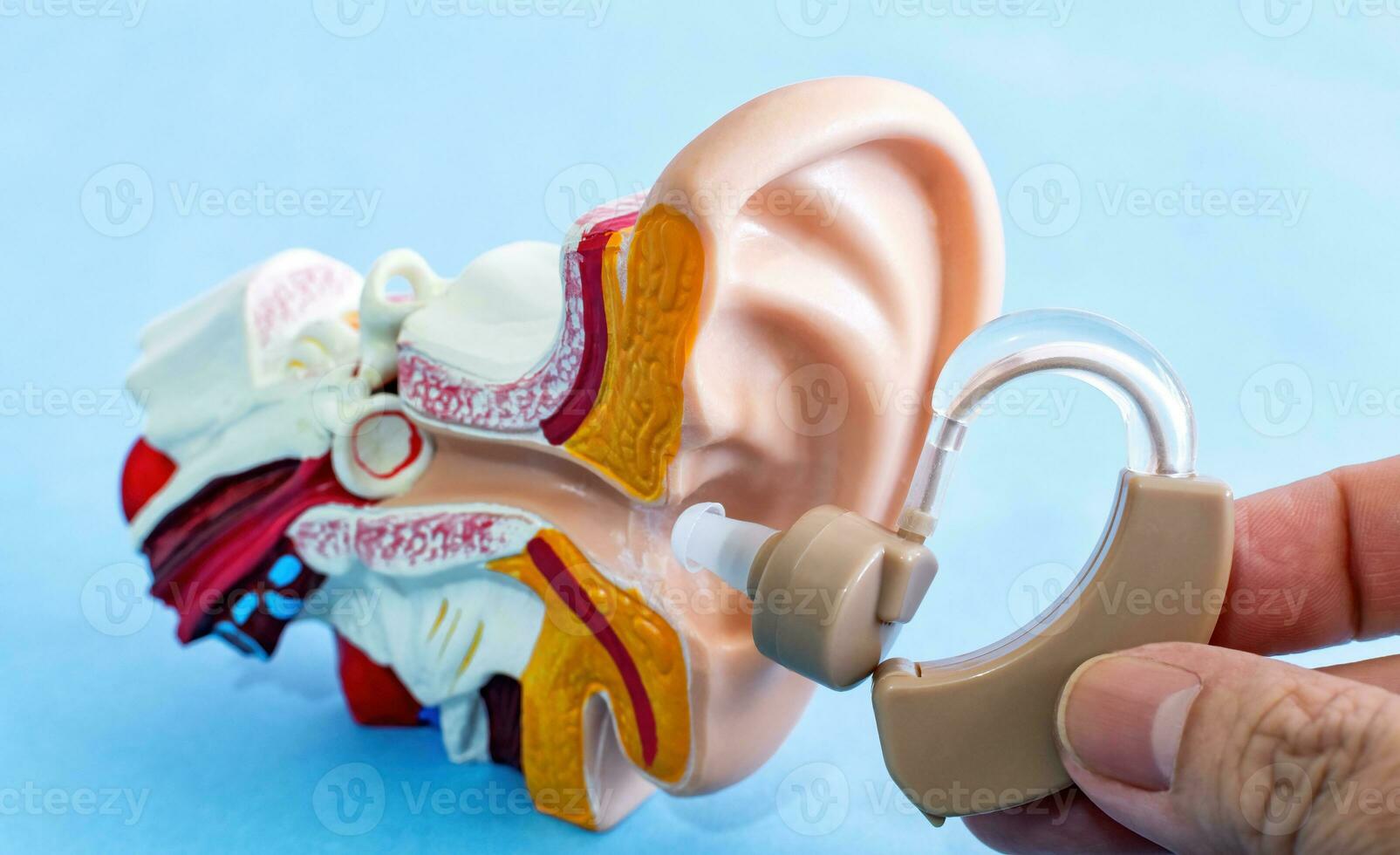 Treatment of deafness for hearing impaired with help of hearing aids. photo