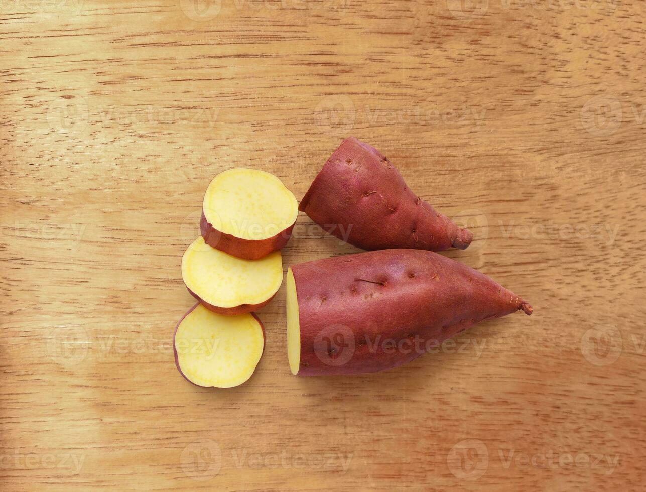 sweet potato isolated on wooden background photo