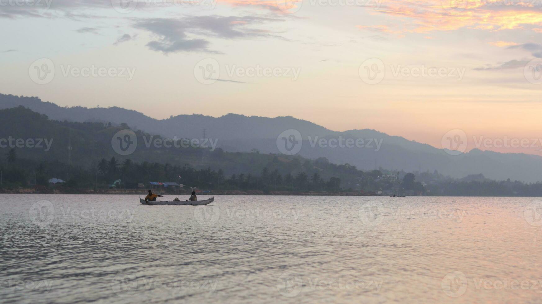 Fisherman Silhouette on His Boat photo