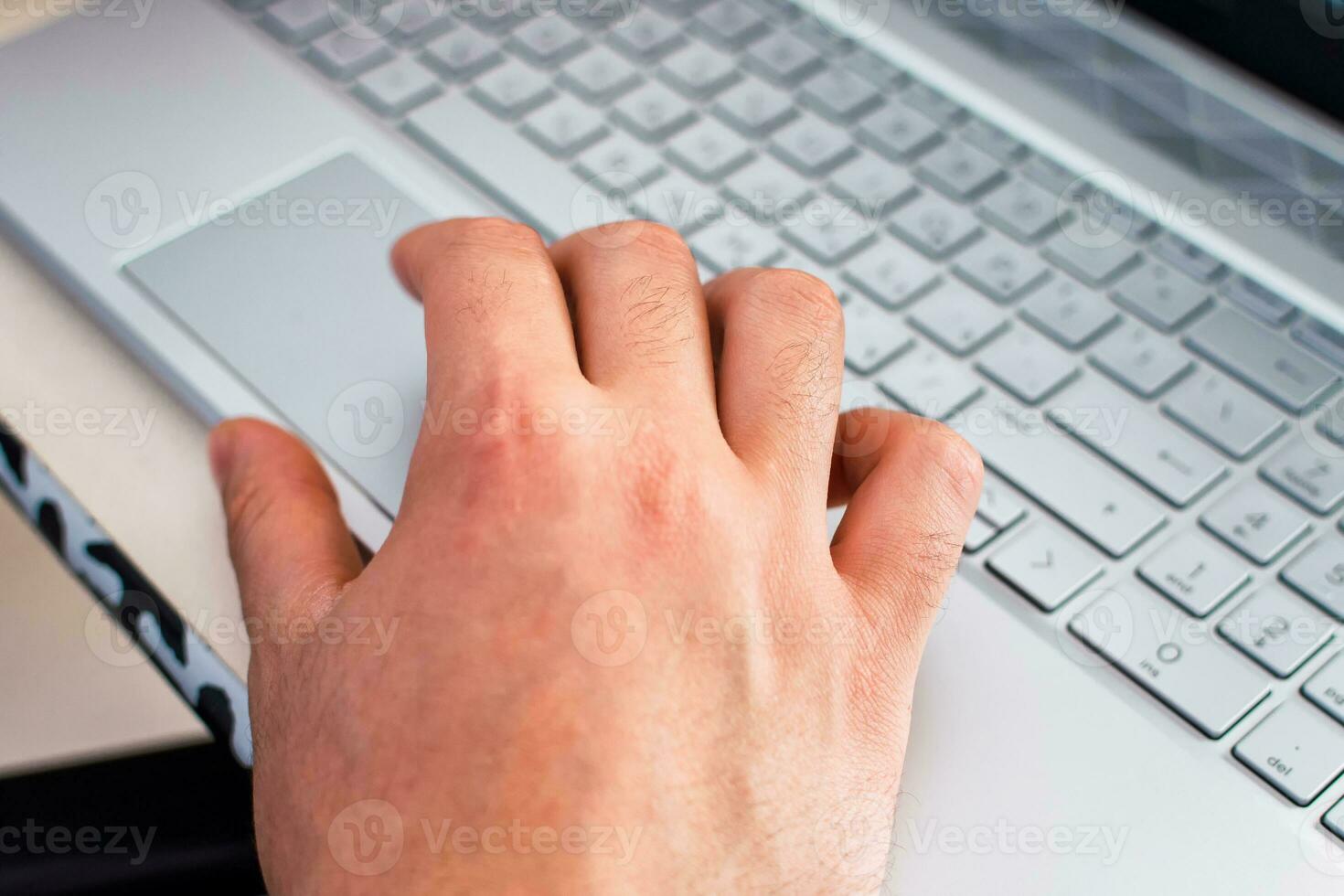 Close up hands multitasking man using laptop. photo