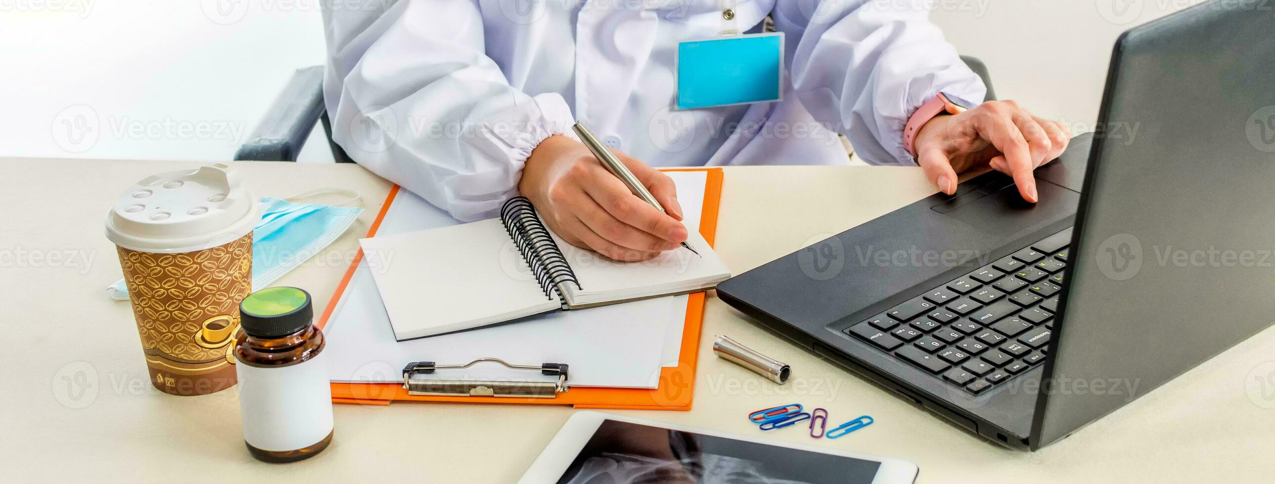 Unknown female hand doctor writes inform on notepad. photo