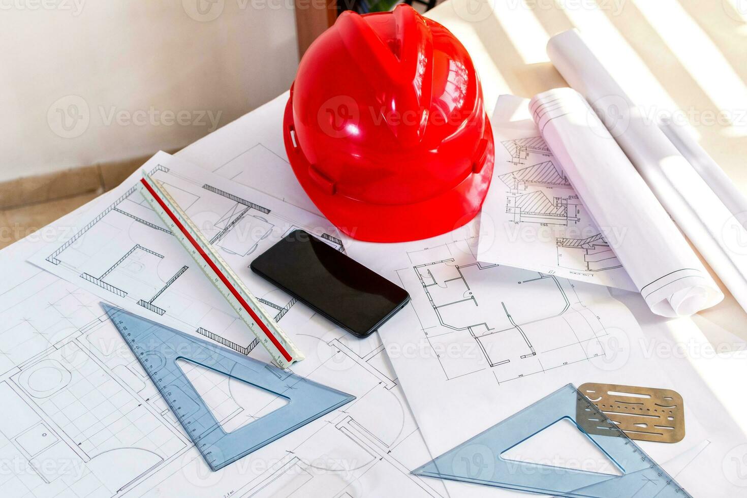 Top view workspace of architectural project with engineering tools, office supplies and smart phone on desk. photo