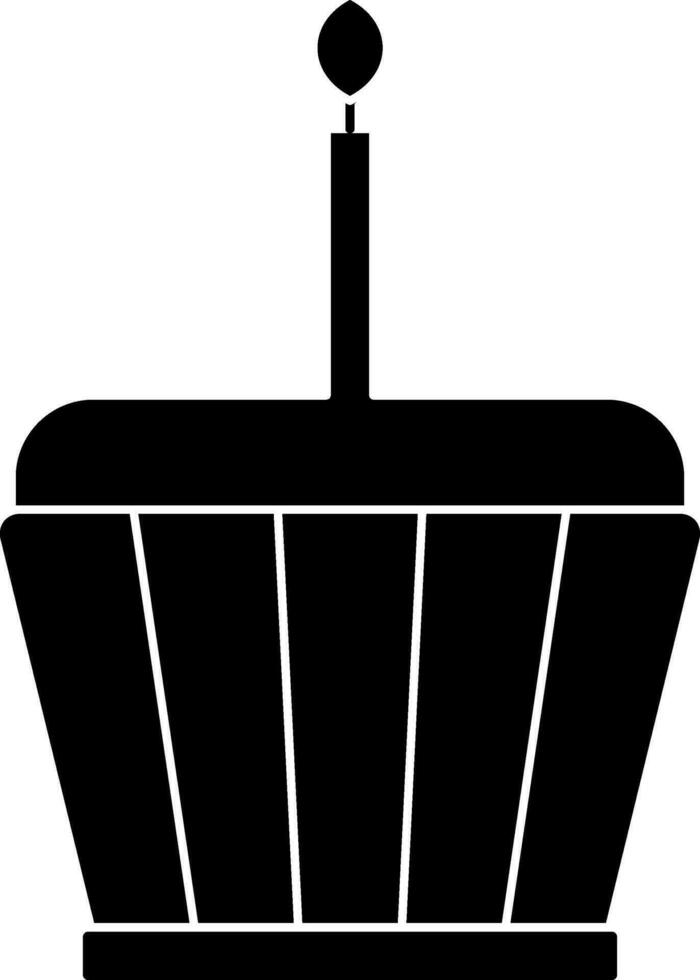 Black and white cupcake with burning candle. Glyph icon or symbol. vector