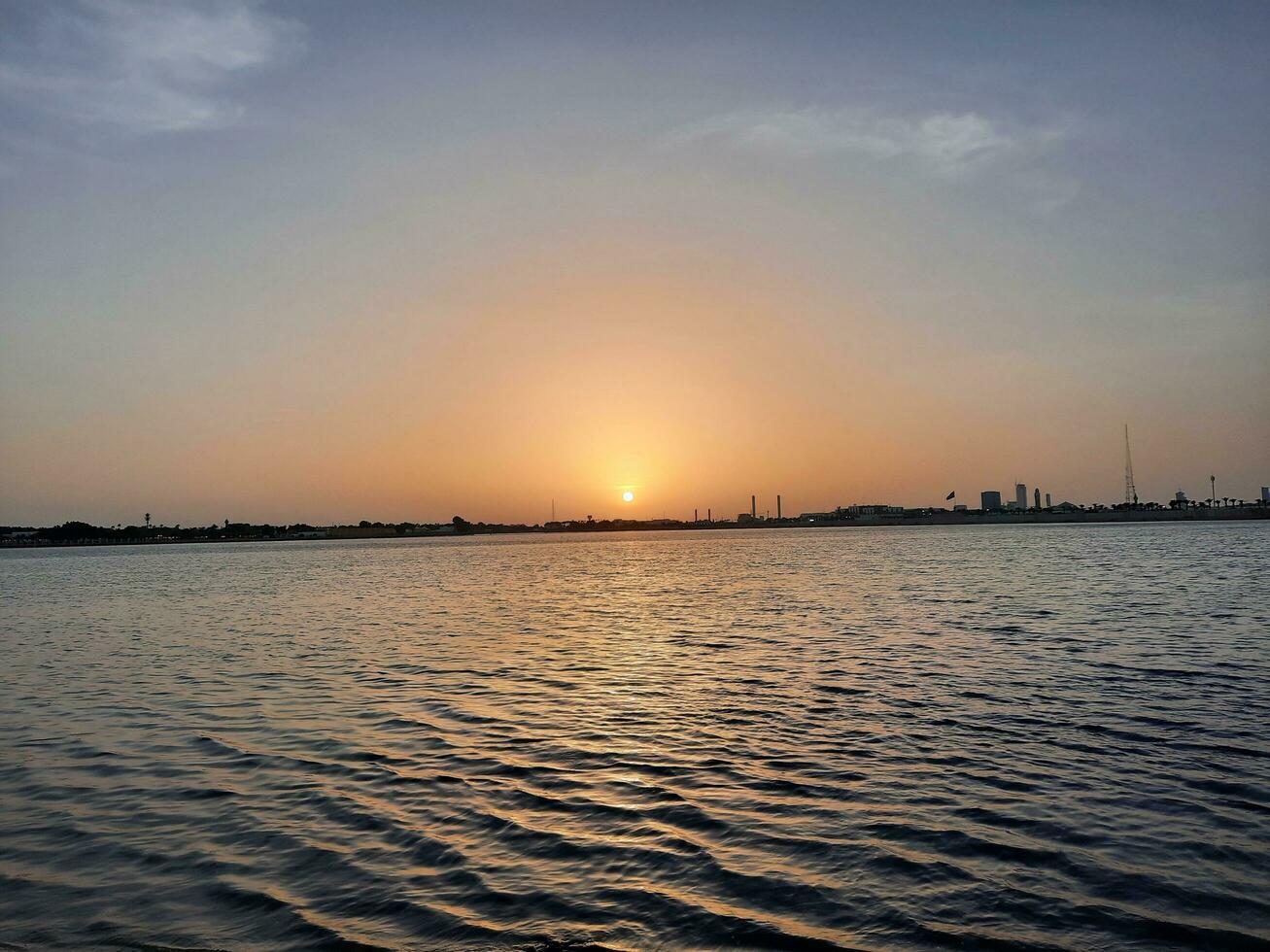 Jeddah, Saudi Arabia, June 2023 - A beautiful view of the sunset at Jeddah Corniche in the evening. photo