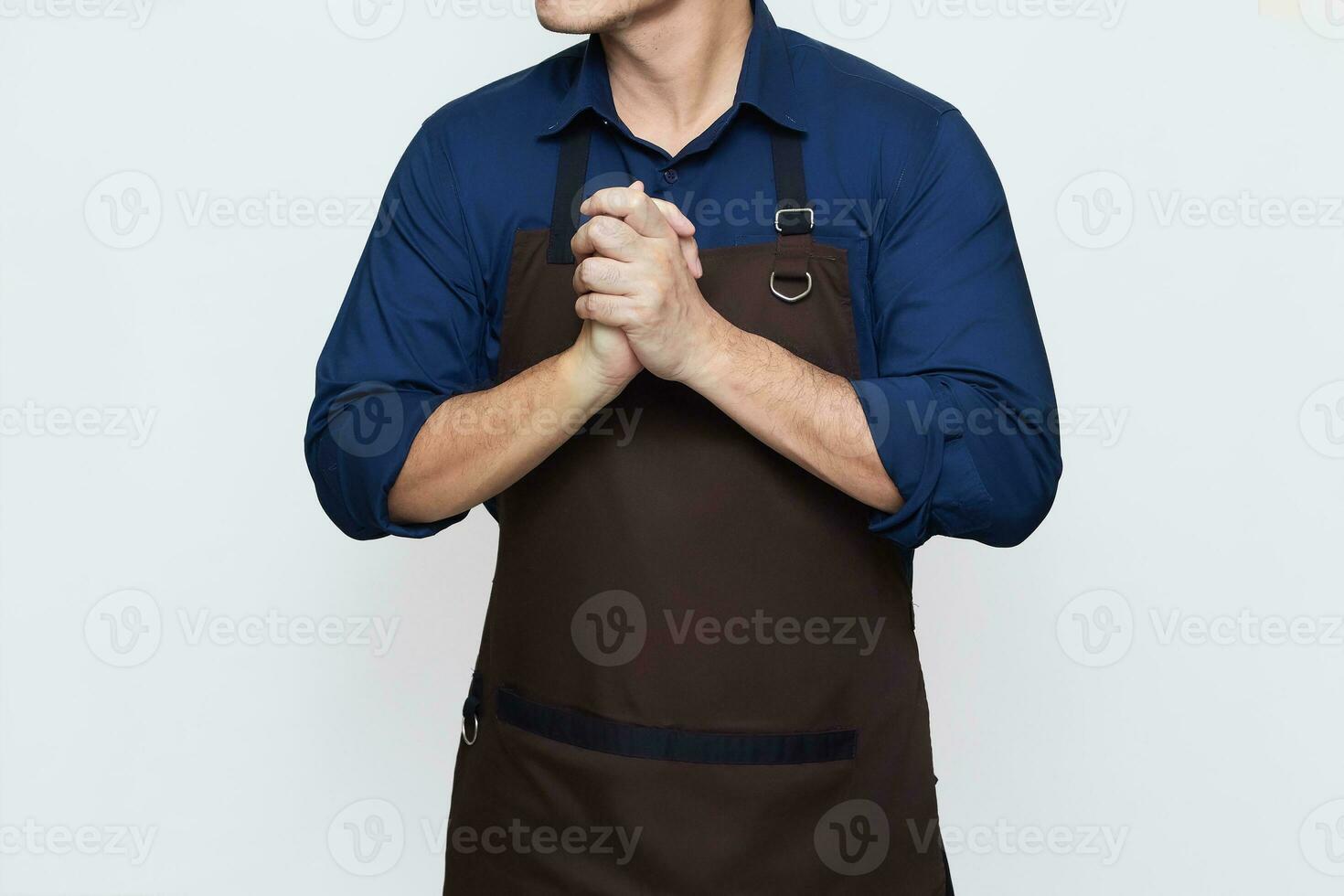 Asian Man wearing Apron in casual stylish clothing, standing tall pose with both hands clasped together, thinking gesture, no face isolated white background photo