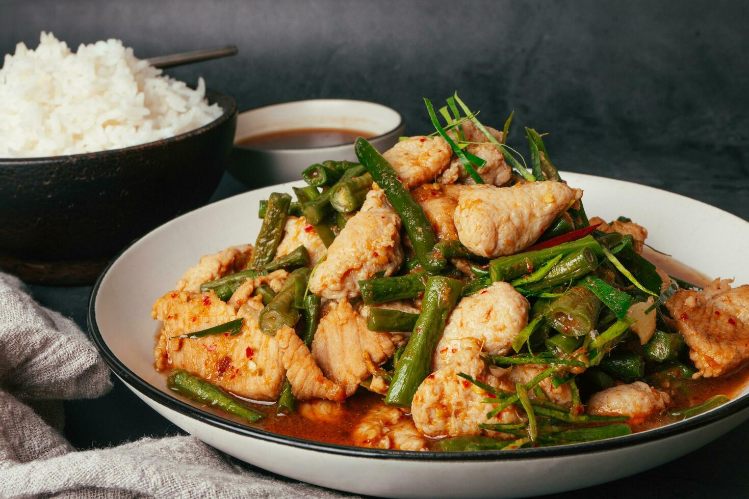 Close up Tasty Stir-fried pork and red hot curry paste with or long bean and Ingredients are oyster sauce, fish sauce, sugar, kaffir lime leaves in the dish Eat with cooked rice. Thai food photo