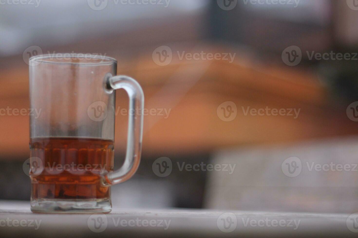 Glass of hot tea against a background of thick fog on a dry summer day. photo