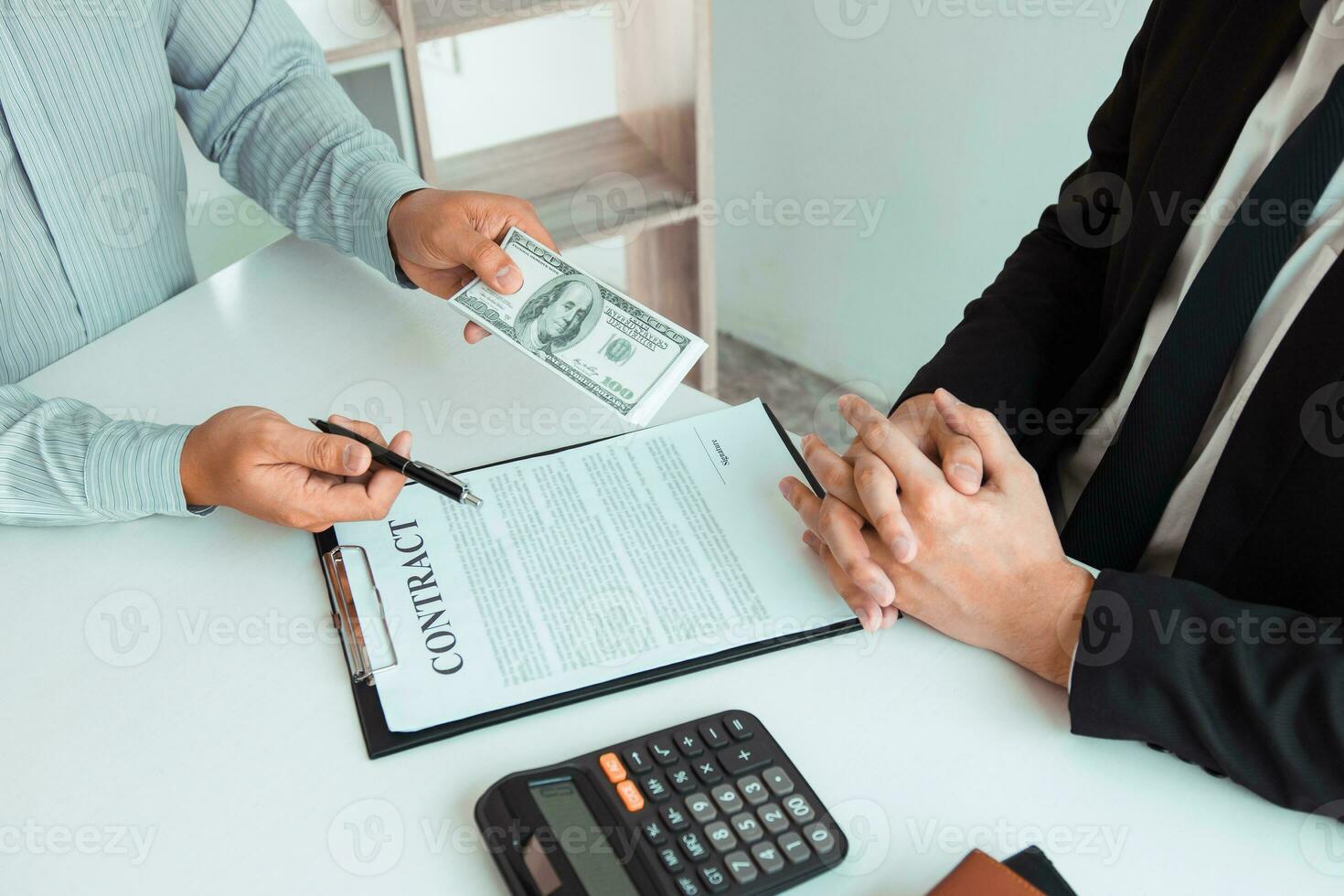 Partner has made a fraud in the contract of sale and being handed a cash and pen to the businessman signing the contract corruption bribery concept. photo