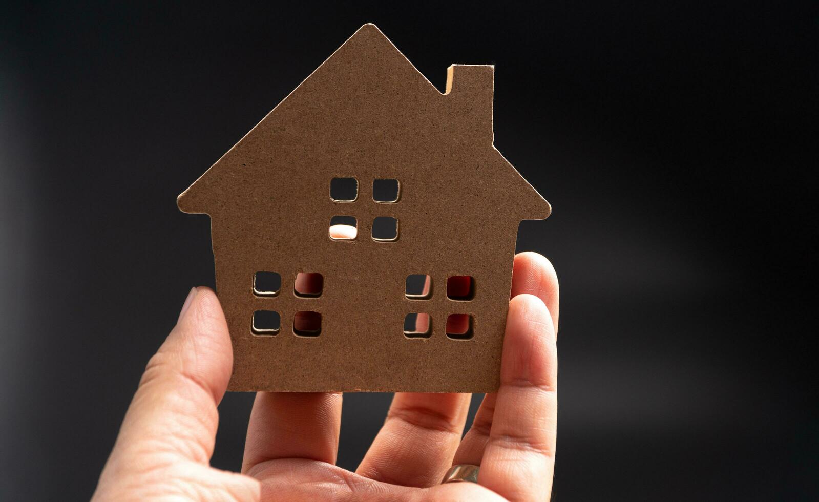 Hand man holding wooden model house. Concept of building construction and home renovation.Hand man holding wooden model house. Concept of building construction and home renovation. photo