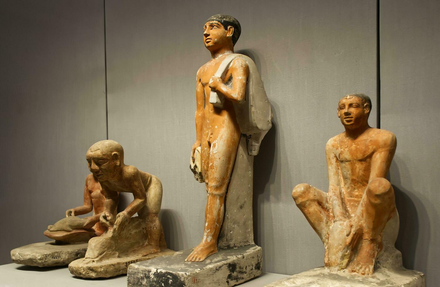 Cairo Egypt  March 18, 2023 Group of servants kneading bread. The Egyptian Museum in Cairo. photo