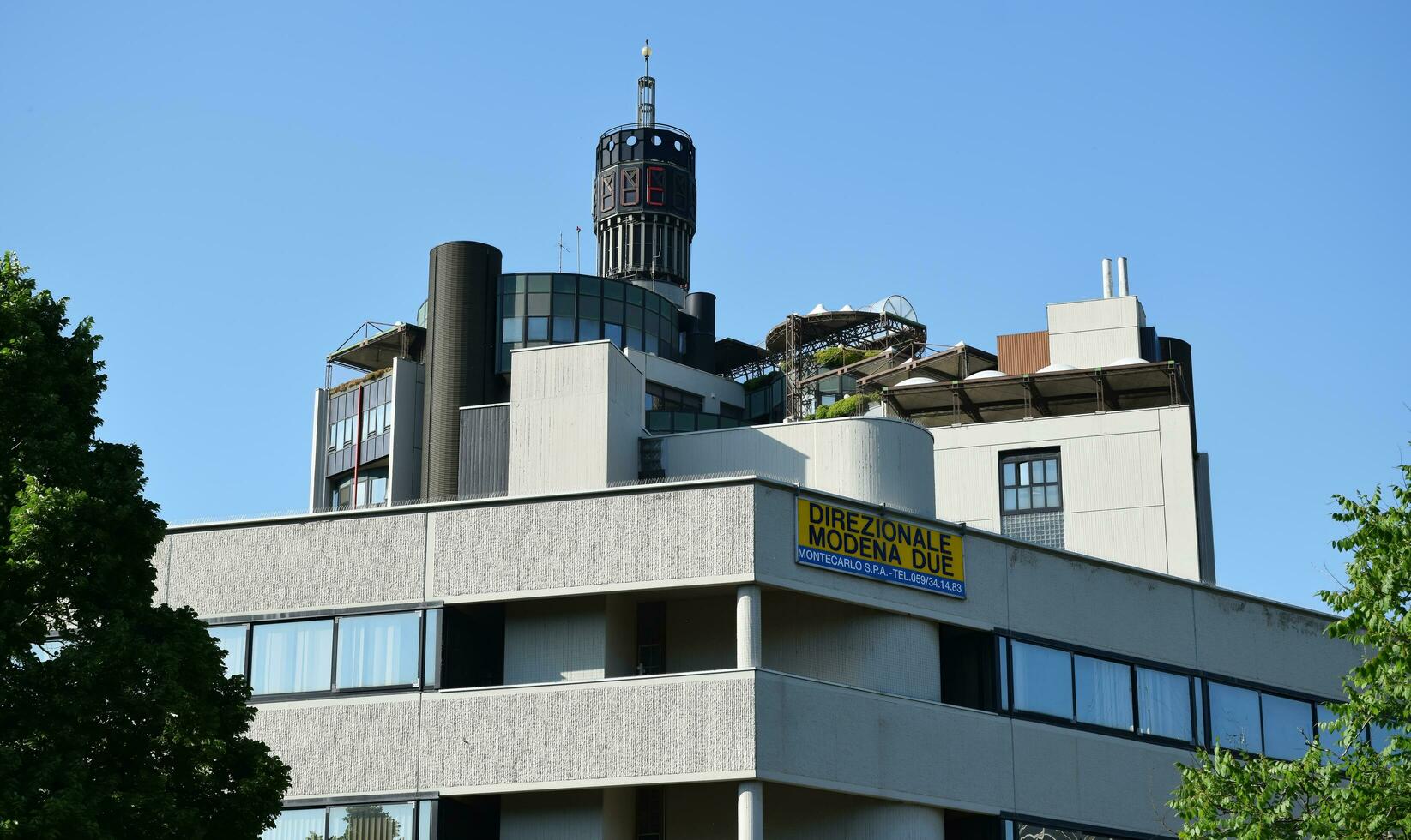 Modena  Italy, May 12, 2022 Direzionale Modena 2 famous commercial complex in the city of Modena. 80's Vintage buildings architecture. Italy photo