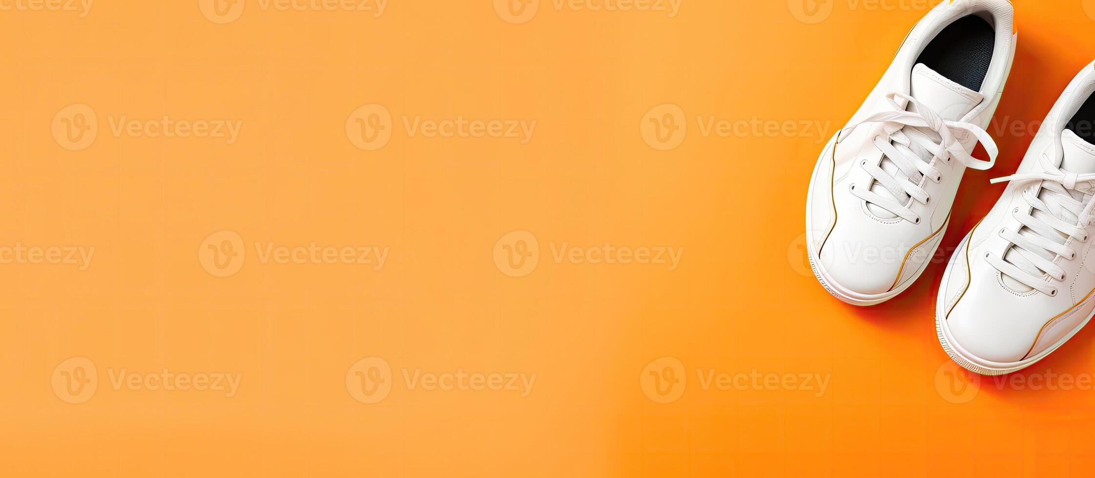 A pair of white tennis shoes on an orange background created with Generative AI technology photo