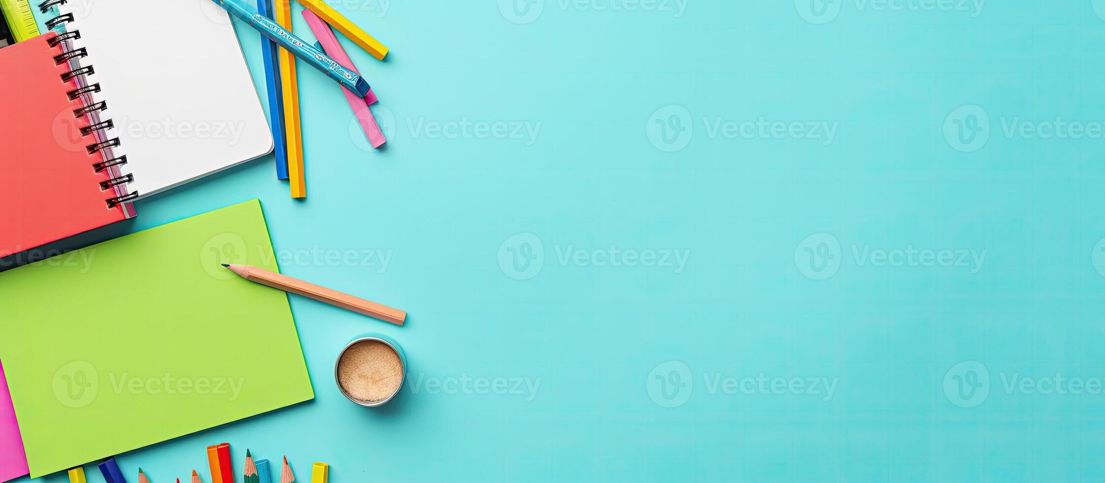 A notebook, pencils, and other office supplies on a blue background created with technology photo