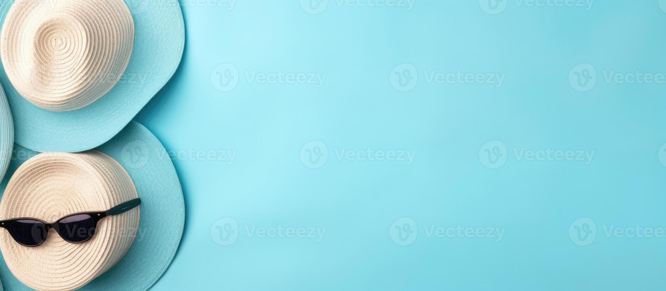 Two hats and sunglasses on a blue background created with technology photo