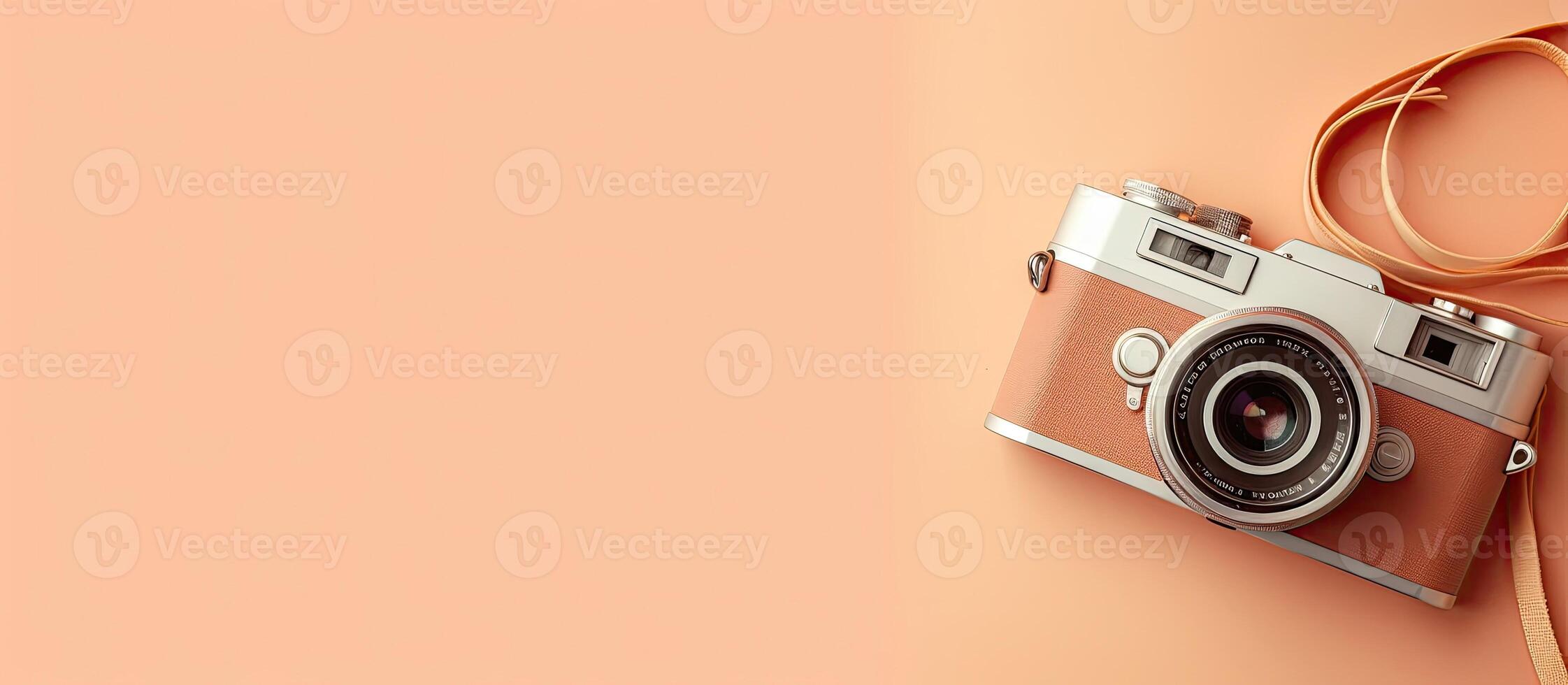 A camera with a strap on a pink background created with technology photo