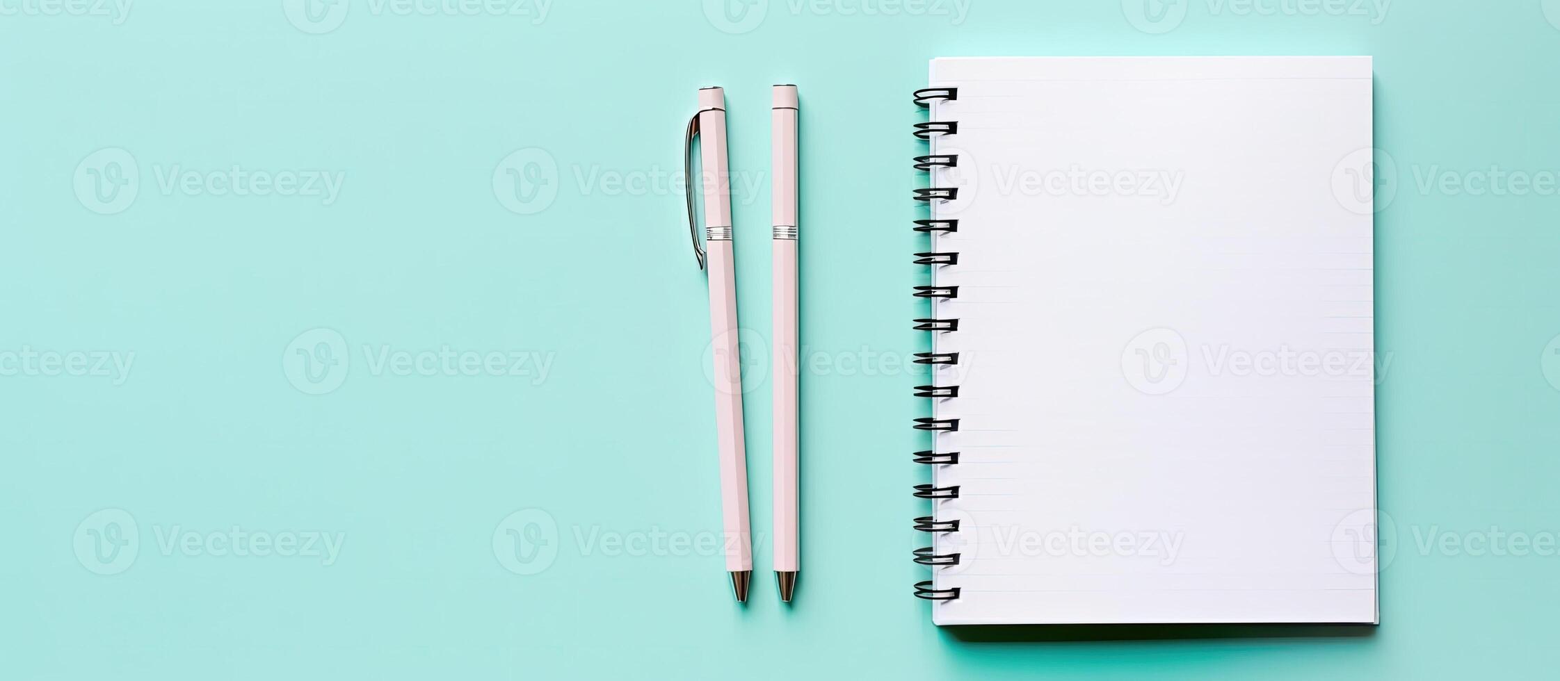 A notebook and pen on a blue background created with technology photo