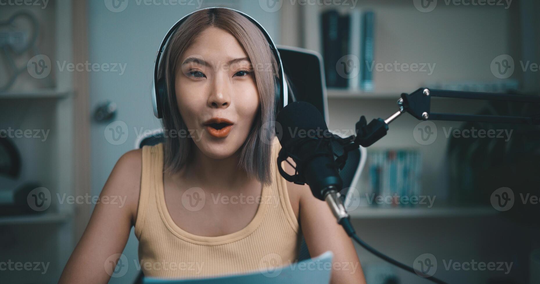 Cheerful Young podcaster use microphone during online podcast in studio photo