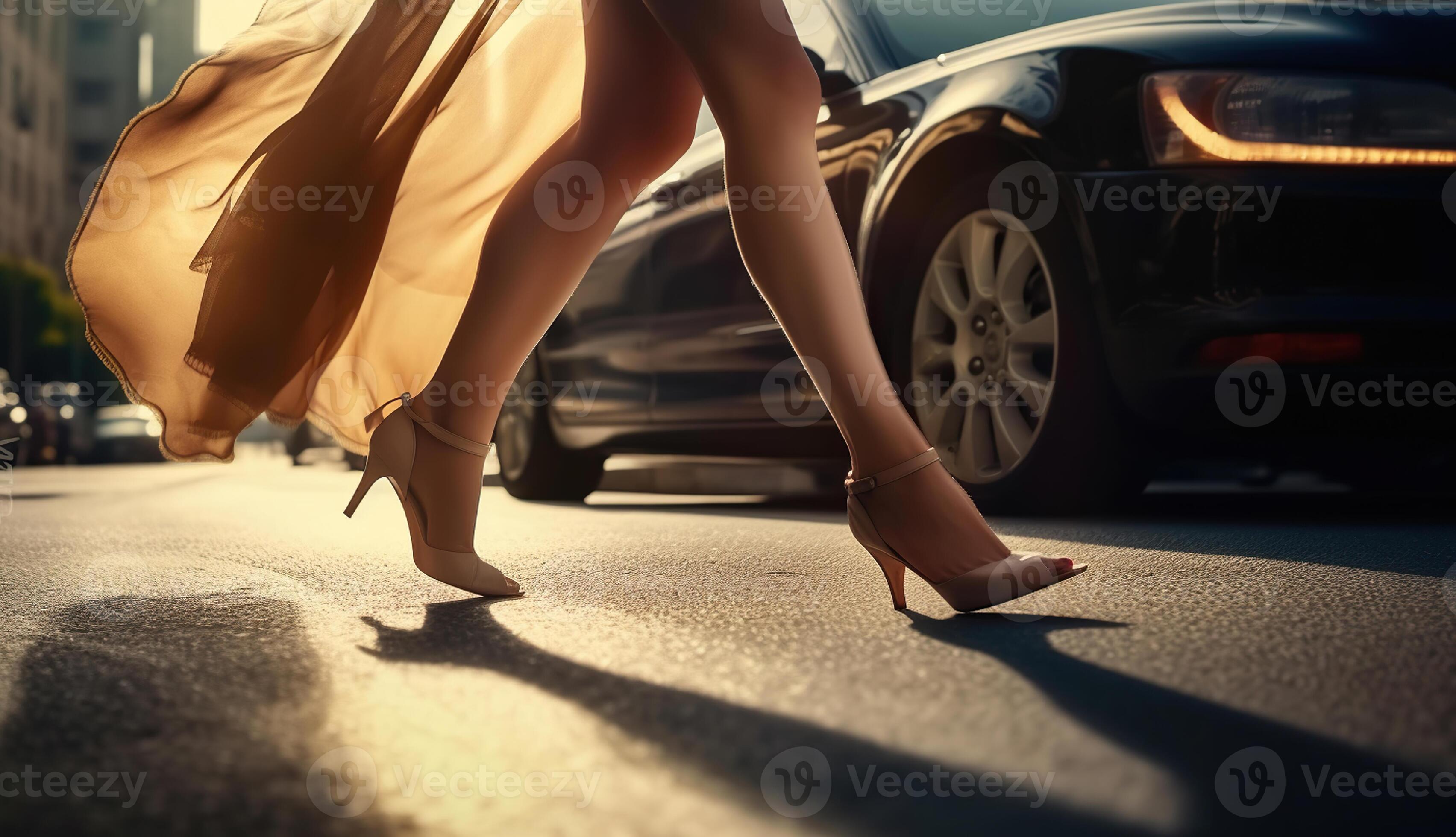 Female feet high heels running on sunny city street among cars and