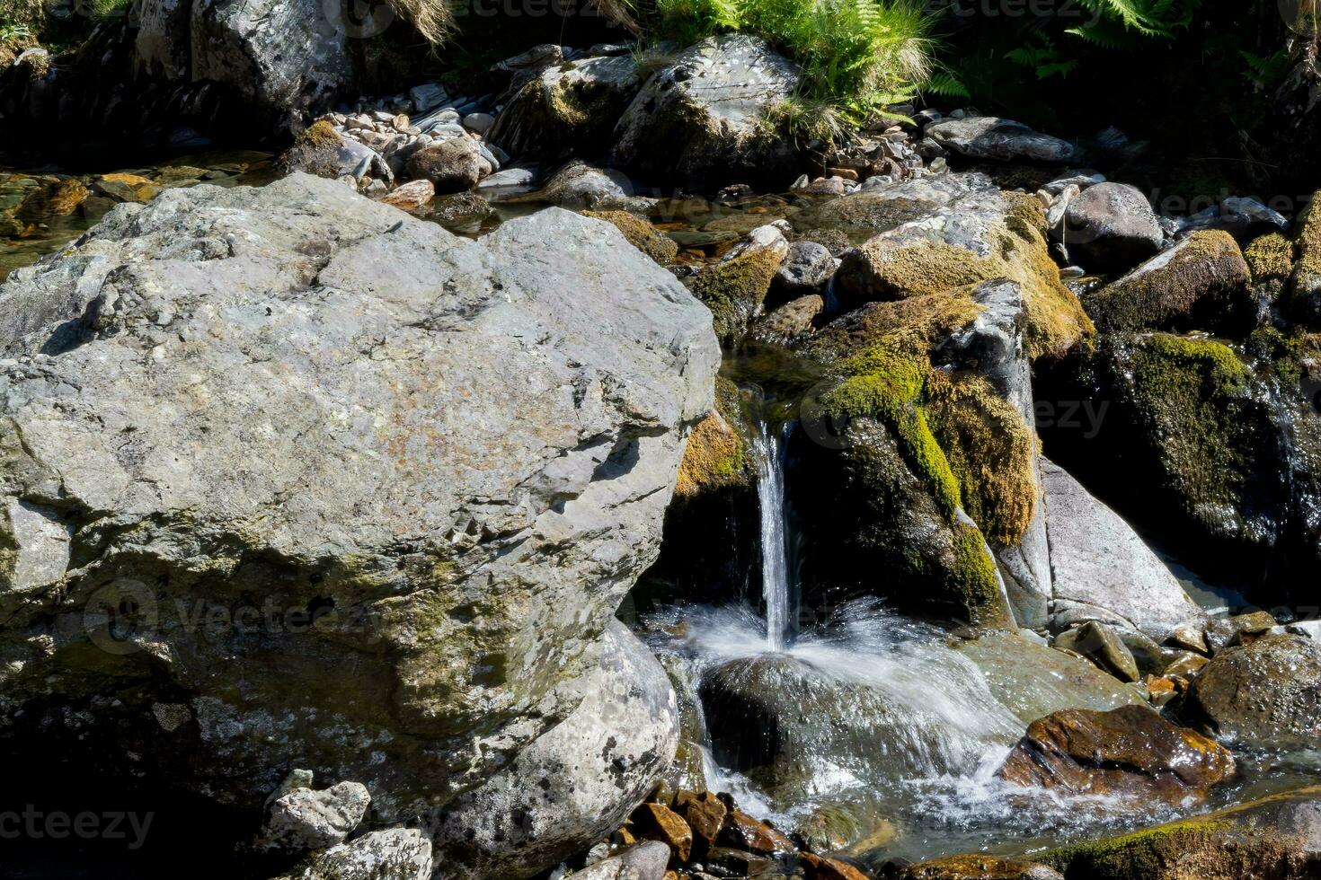 Water trickling over rocks in a Welsh river in springtime photo