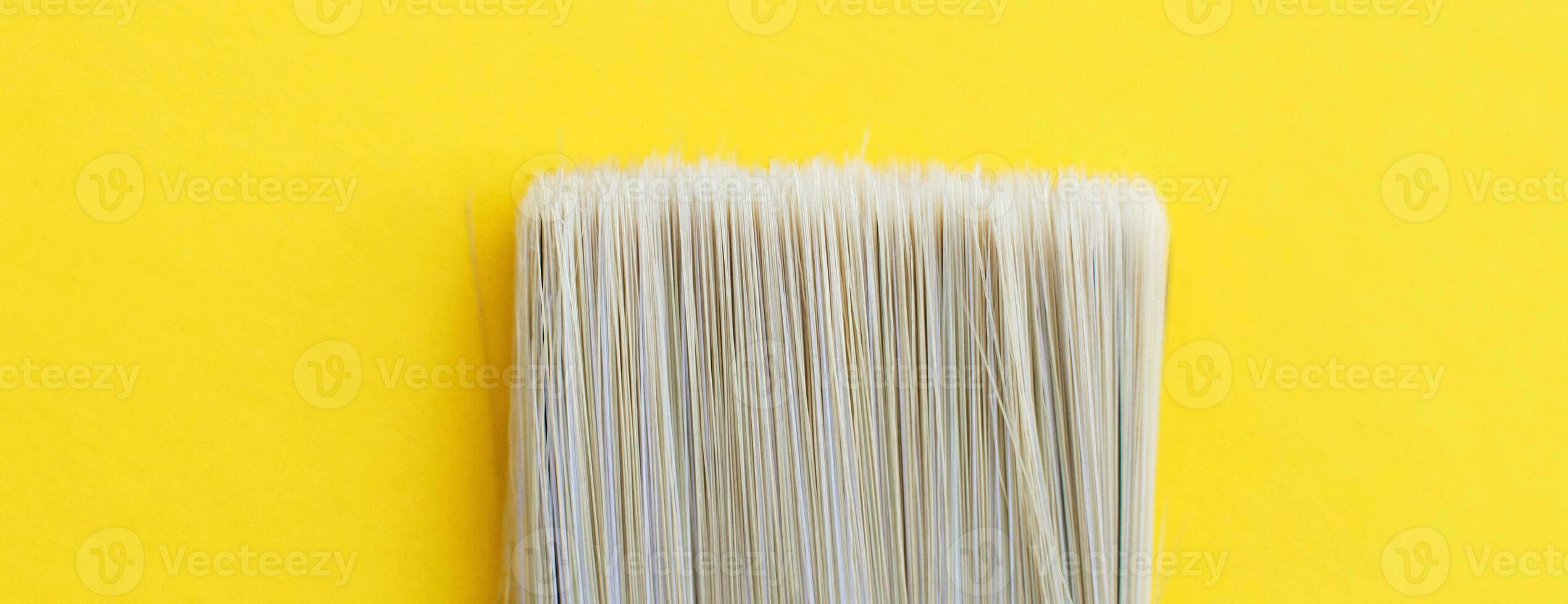Paint brush isolated on a yellow background close with copy space. banner photo