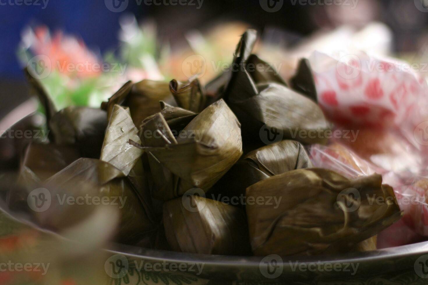 lemper, a traditional snack from Indonesia made of glutinous rice with shredded beef filling, selective focus at the place of celebration. photo