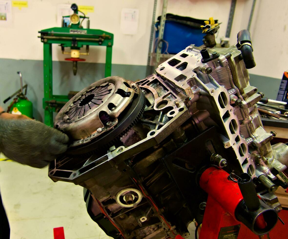 a car engine being assembled on an engine stand in a garage photo