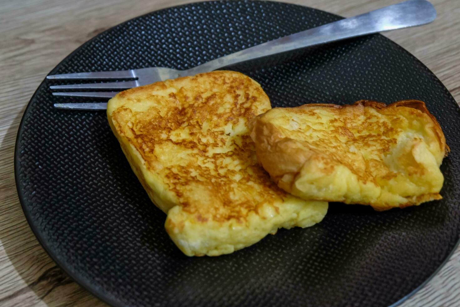 delicious toast on a black plate and a fork photo