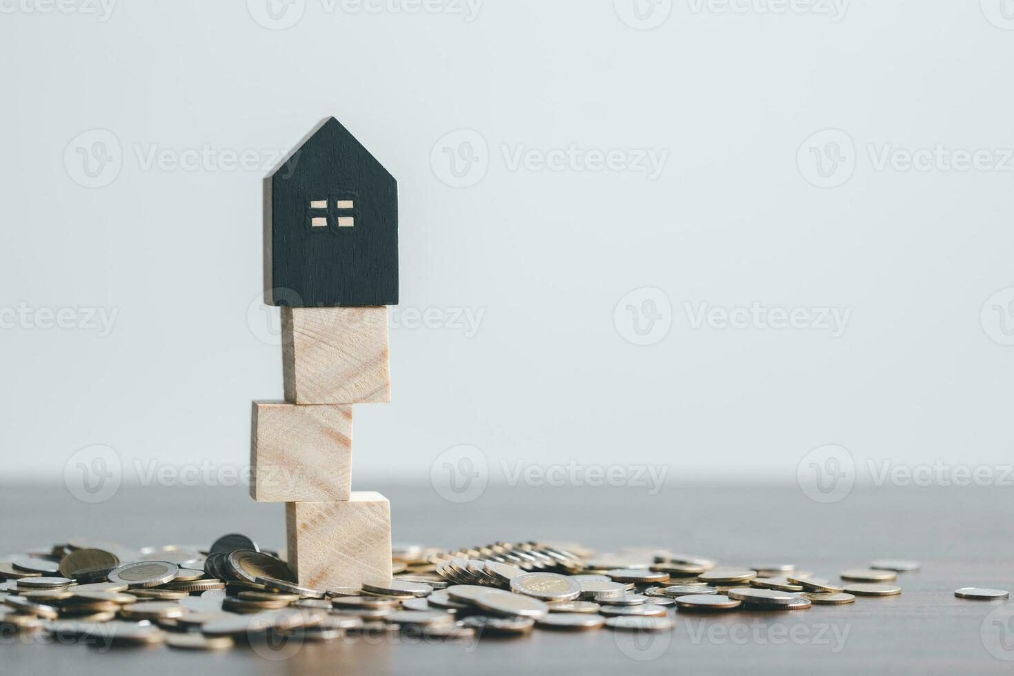 Stack coin on and home model for family put on top in office, Business investment loan for real estate or save money for buy new house in future concept. Planning to buy property. photo
