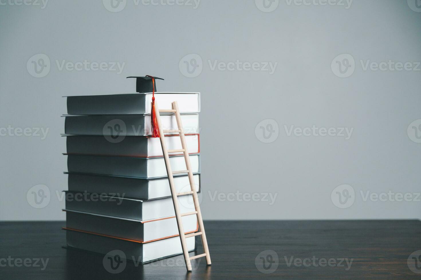 A studying climbing up to the book stack. A concept of education process. Copy space for text. Distance education, e-learning concept. scale that reaches knowledge and freedom. photo