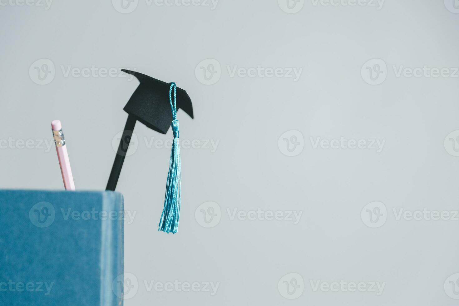 Concept of graduate educational for long distane learning anywhere anytime.Education to learn study in world.Graduated student studying abroad international idea.Master degree hat on top globe book. photo