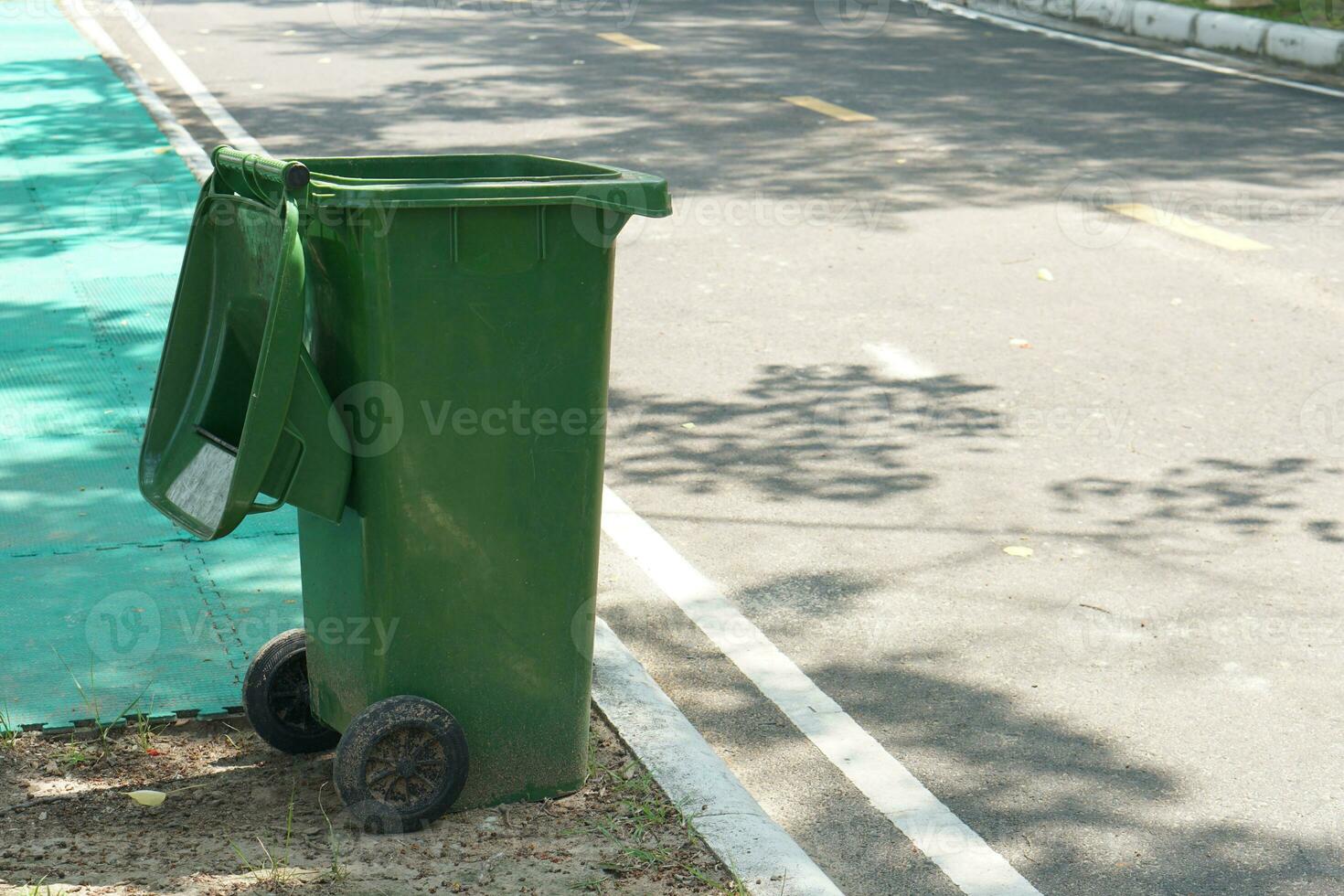Green trash can in the park 25405814 Stock Photo at Vecteezy