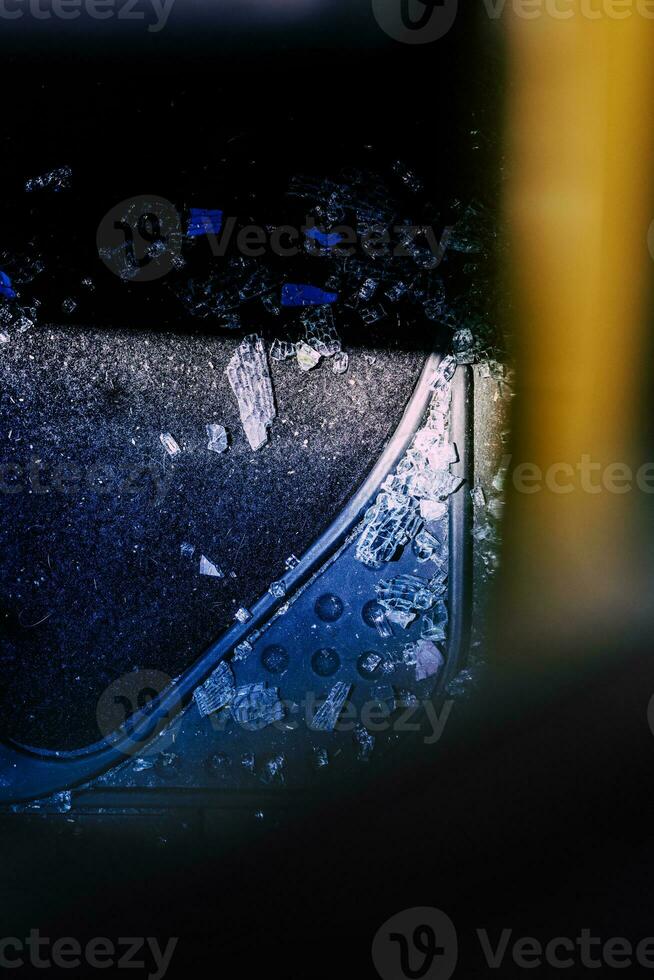 Broken car window and cracked glass of a automobile following attempted theft photo